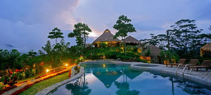 98 Acres Resort chalets perched above the scenic tea valleys of Ella