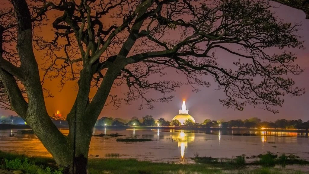 Illuminated Ruwanwelisaya stupa at dusk in Anuradhapura