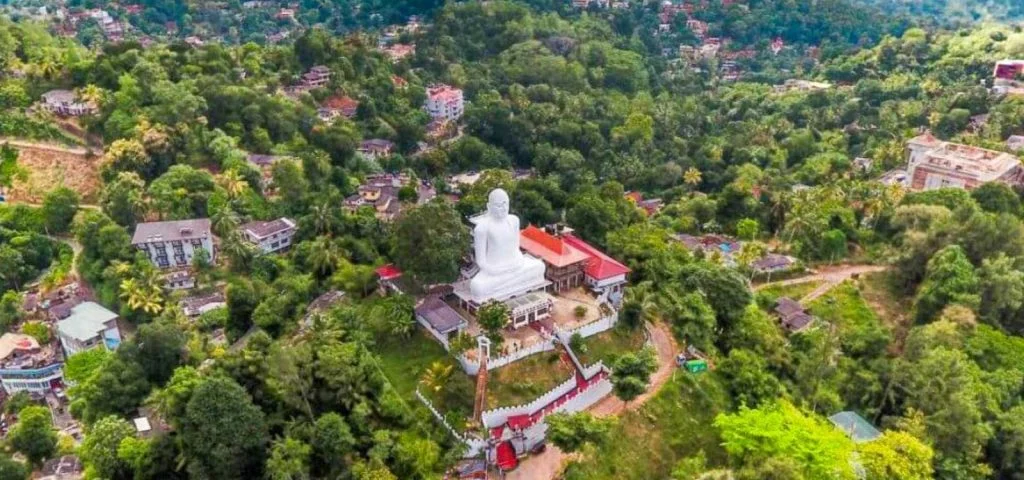 Colossal white Bahirawakanda Buddha statue overlooking Kandy city