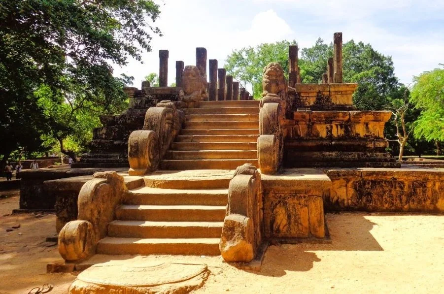Carved stone tiers and guardian lion statues at the Council Chamber of King Parakramabahu