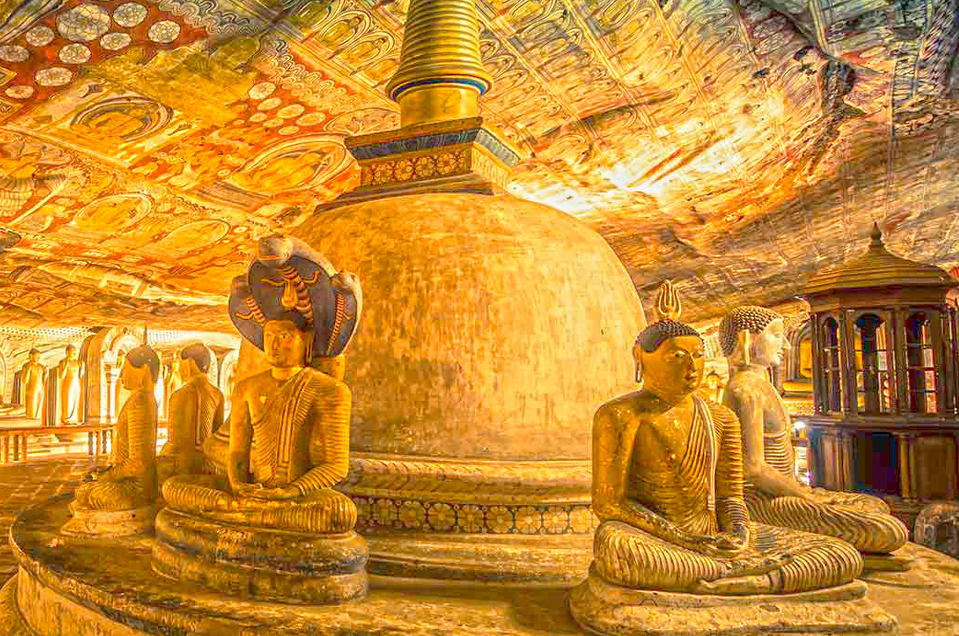 Devana Aluth Viharaya cave featuring the reclining Buddha and Guardian deity murals
