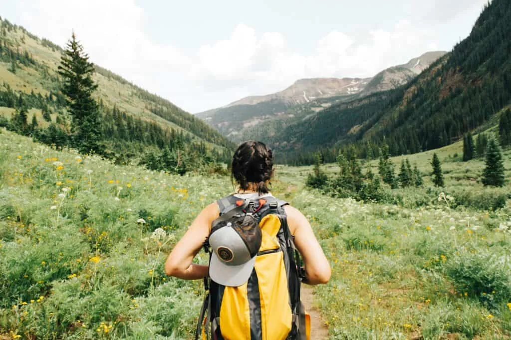 Young backpacker trekking scenic trails overlooking valleys in Ella
