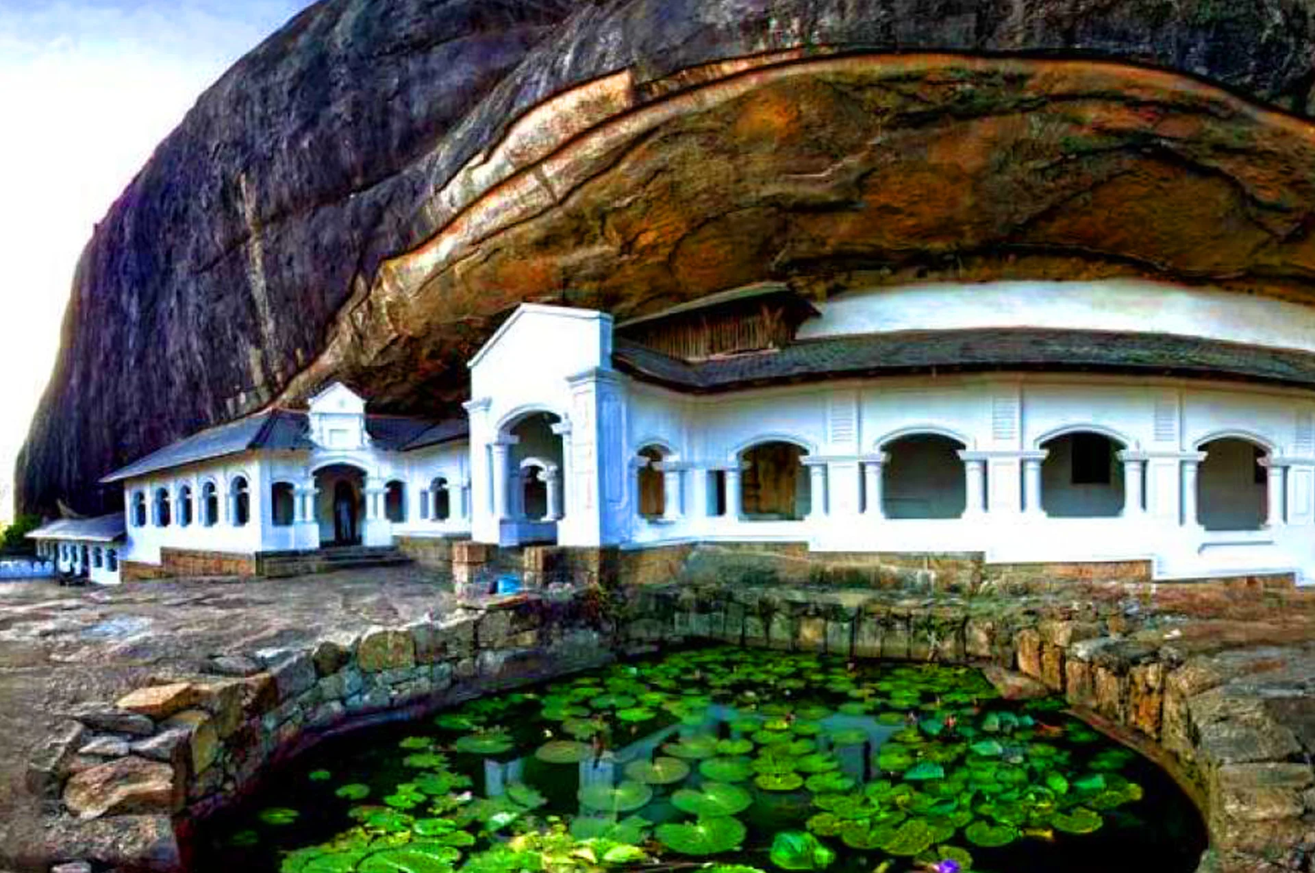 The Maharaja Lena cave featuring ancient ceiling frescoes, Buddha statues, and Makara Torana