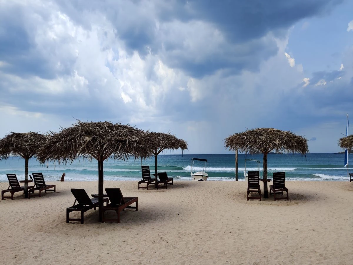 Nilaveli Beach shoreline with lawn chairs along the sand