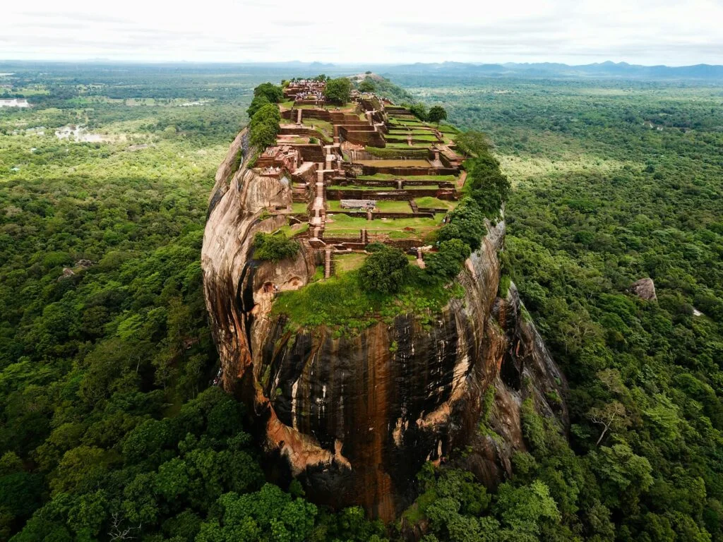 Dramatic ancient Sigiriya Rock Fortress rising above morning mist