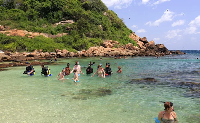 Snorkelers exploring the calm turquoise shallows of Pigeon Island