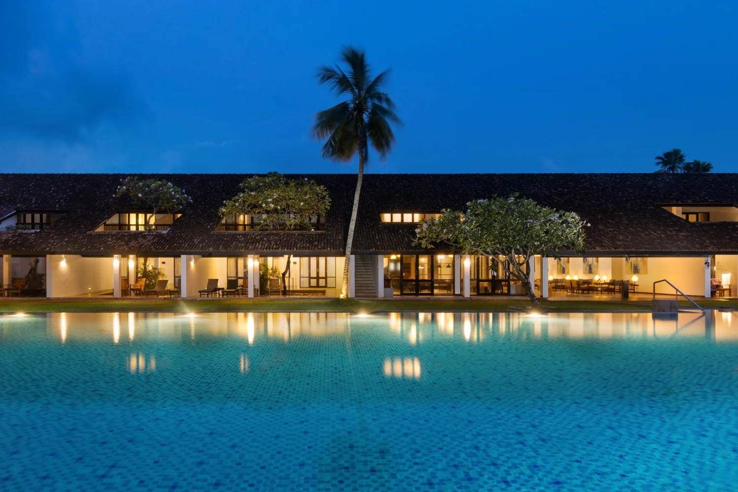 Tranquil swimming pool and beachfront grounds at Thaala Bentota Resort