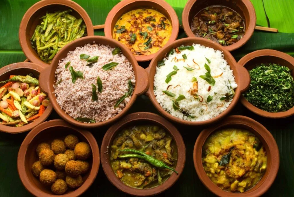 Traditional Sri Lankan rice and curry spread with colorful vegetable and meat dishes