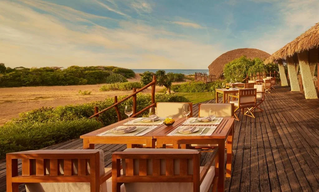 Open-air dining pavilion and starlit ambiance at Uga Chena Huts