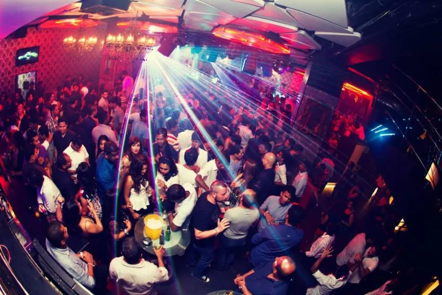 Energetic nightclub atmosphere with DJ and lights in Sri Lanka
