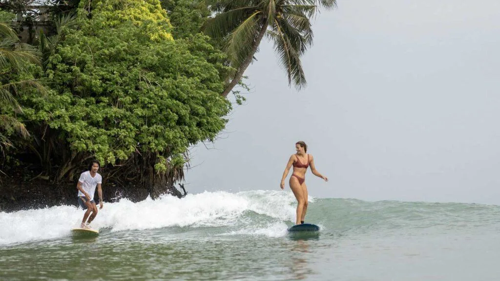 Surfers enjoying waves at Weligama Bay
